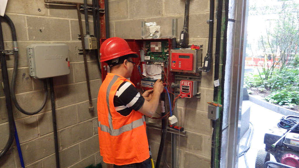 Electrician Installing Phone Wires for Fire Alarm
